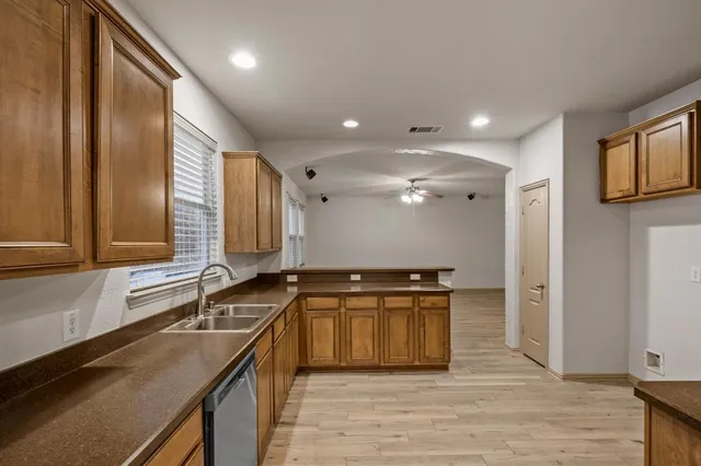 a kitchen with stainless steel appliances granite countertop a sink and a stove