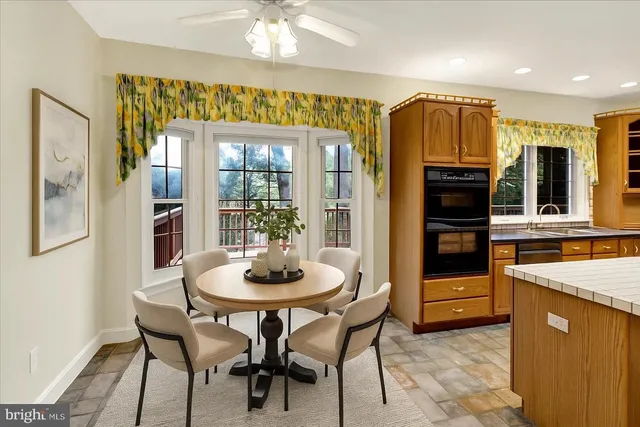 a view of kitchen with stainless steel appliances granite countertop a stove and a sink