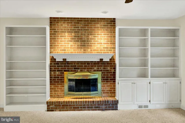 en empty room with a fireplace and windows