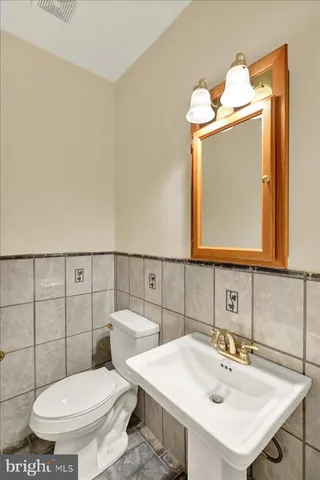 a living room with furniture a window and a potted plant