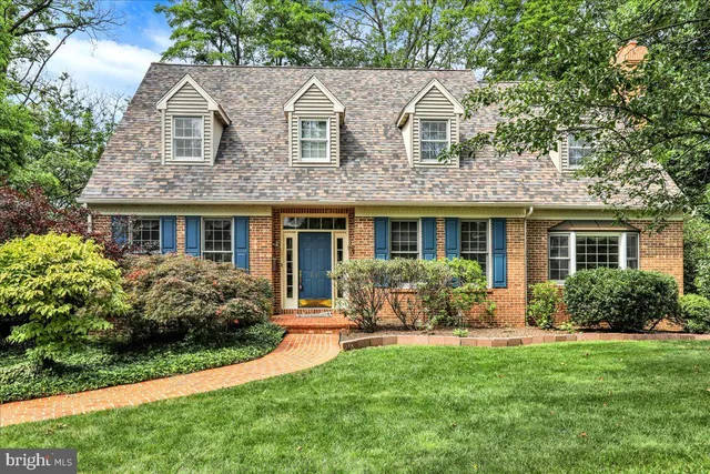 a front view of a house with yard and green space