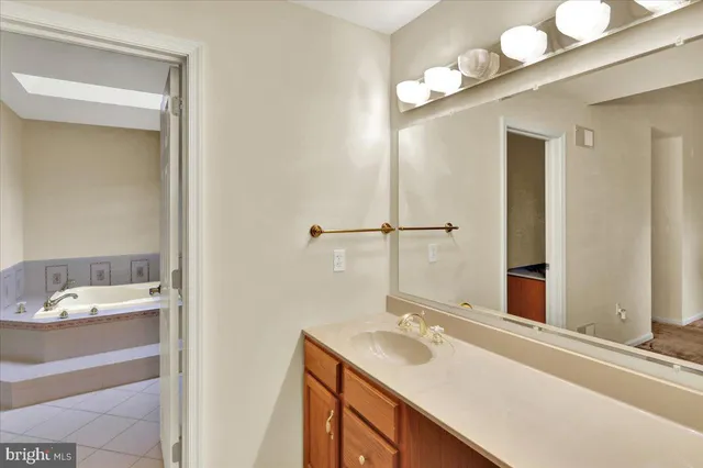 a living room with furniture a chandelier and a potted plant