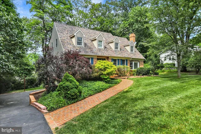 a view of house with garden space and trees