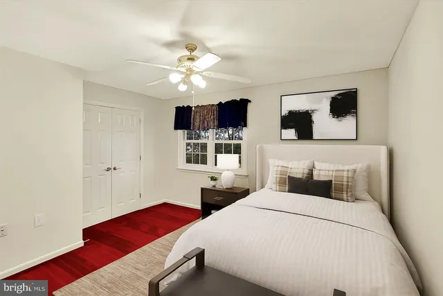 an empty room with windows and ceiling fan