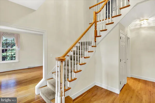 a view of entryway with wooden floor and stairs