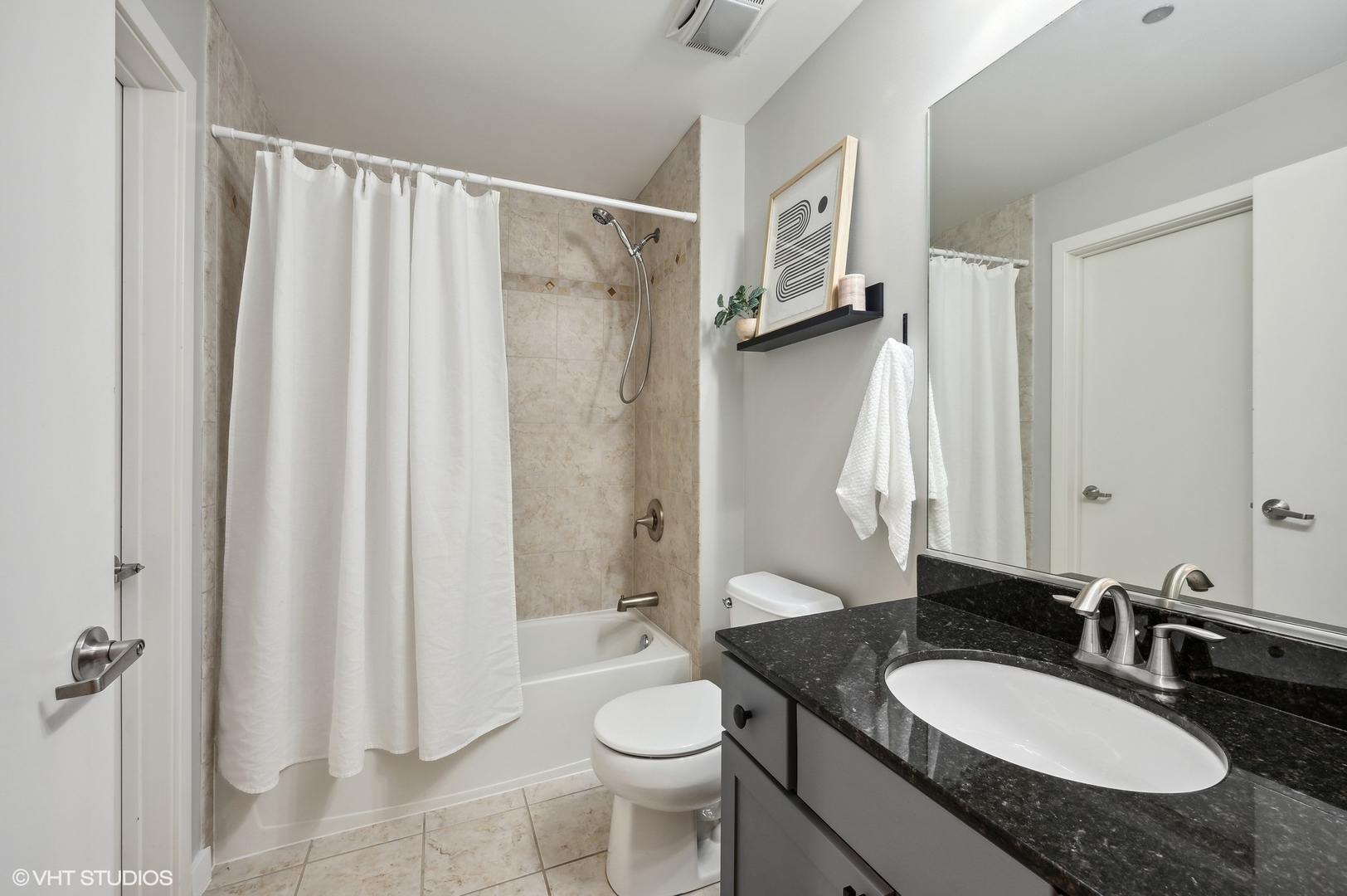 520 South State Street, Unit 908 Chicago, IL 60605 - Photo 12 of 16 a bathroom with a granite countertop sink toilet and shower