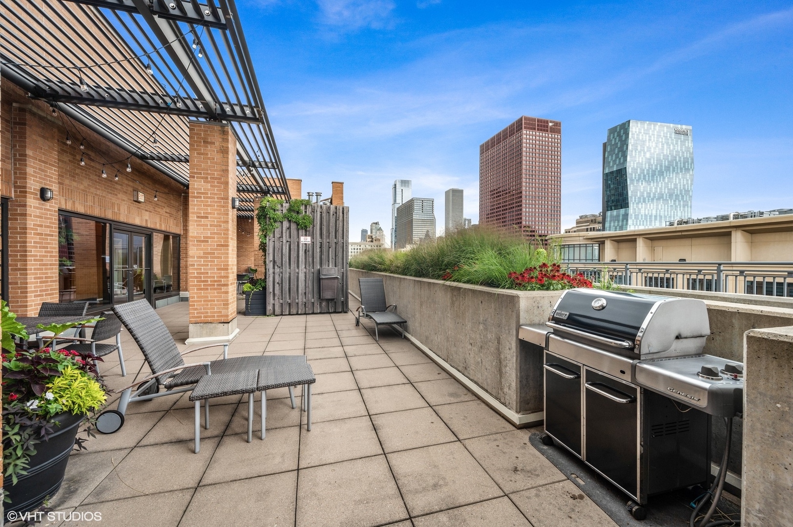 520 South State Street, Unit 908 Chicago, IL 60605 - Photo 16 of 16 a view of a patio with a table and chairs and potted plants