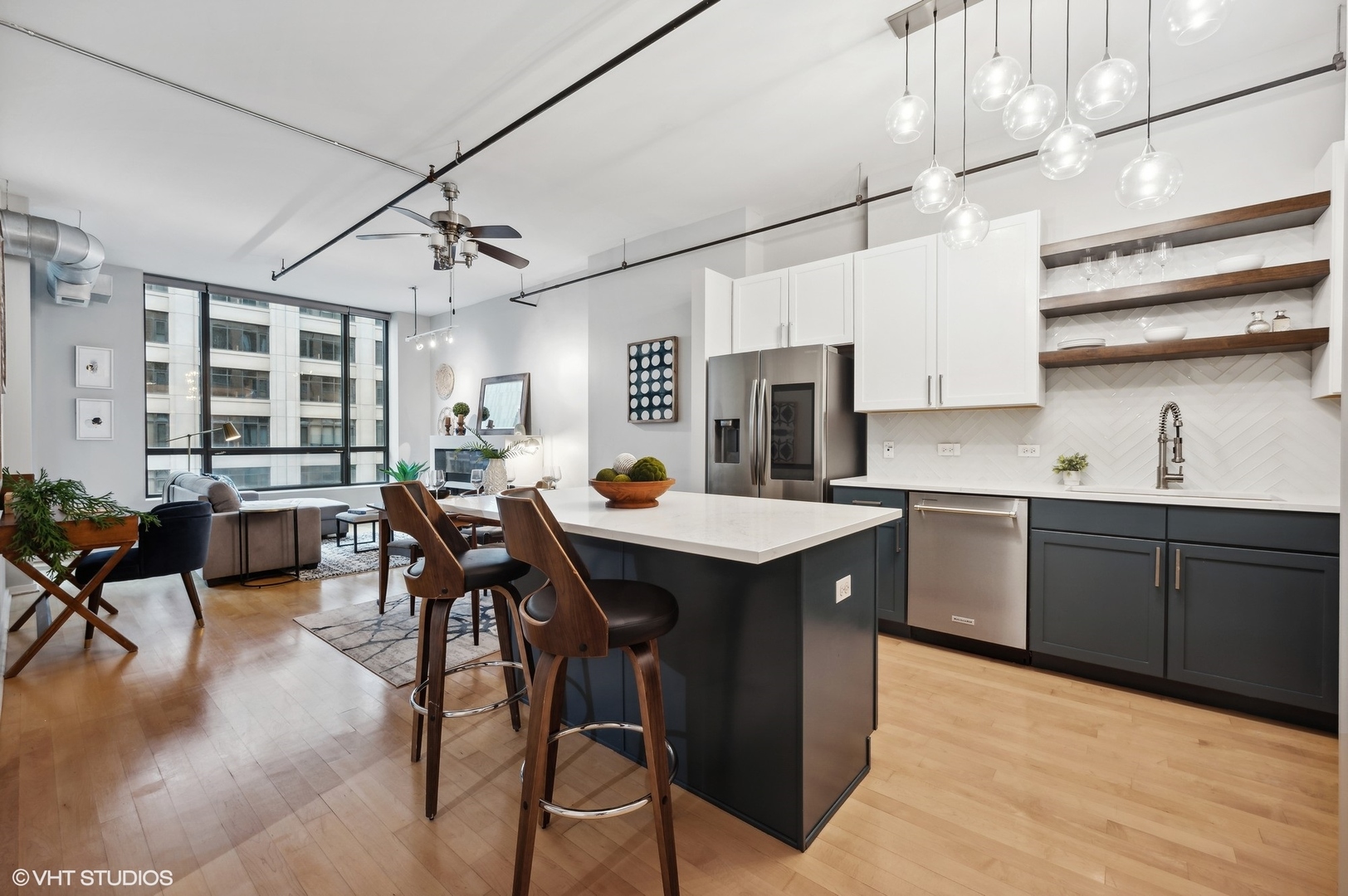 520 South State Street, Unit 908 Chicago, IL 60605 - Photo 3 of 16 a kitchen with stainless steel appliances granite countertop a sink a stove and chairs