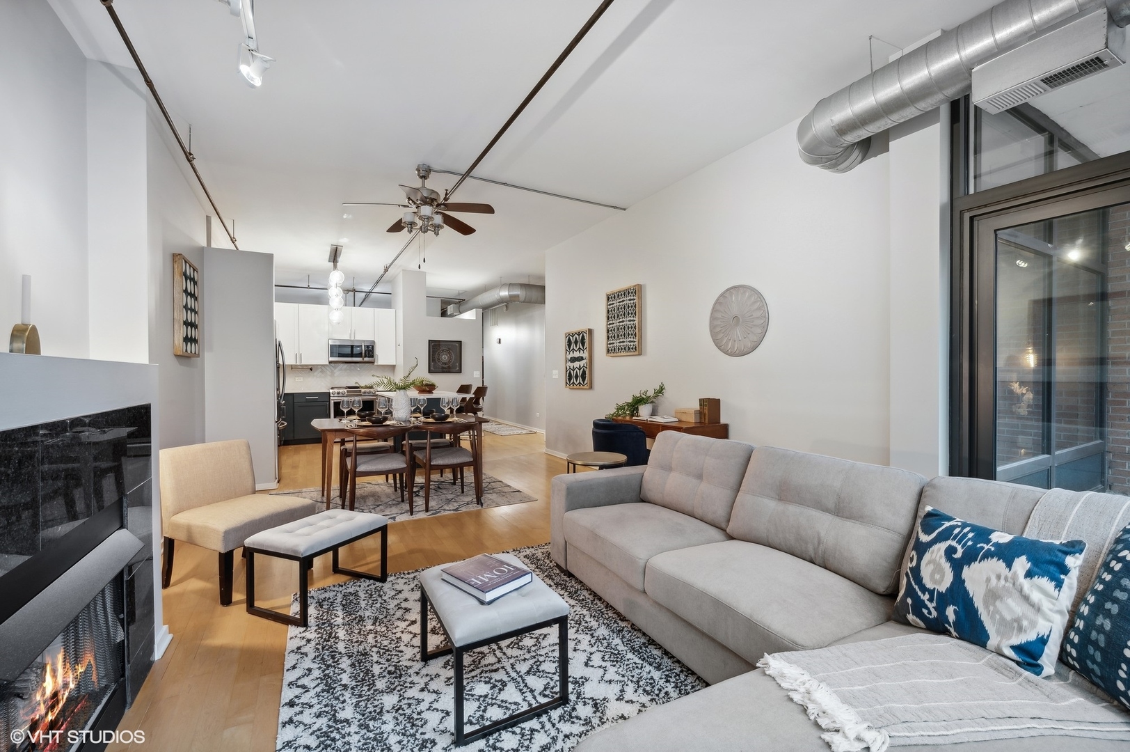 520 South State Street, Unit 908 Chicago, IL 60605 - Photo 5 of 16 a living room with furniture kitchen view and a fireplace
