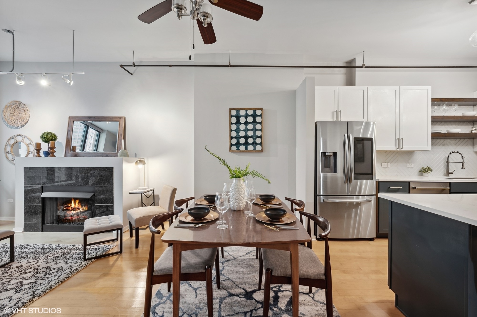 520 South State Street, Unit 908 Chicago, IL 60605 - Photo 6 of 16 a kitchen with stainless steel appliances a stove a refrigerator and a dining table with wooden floor