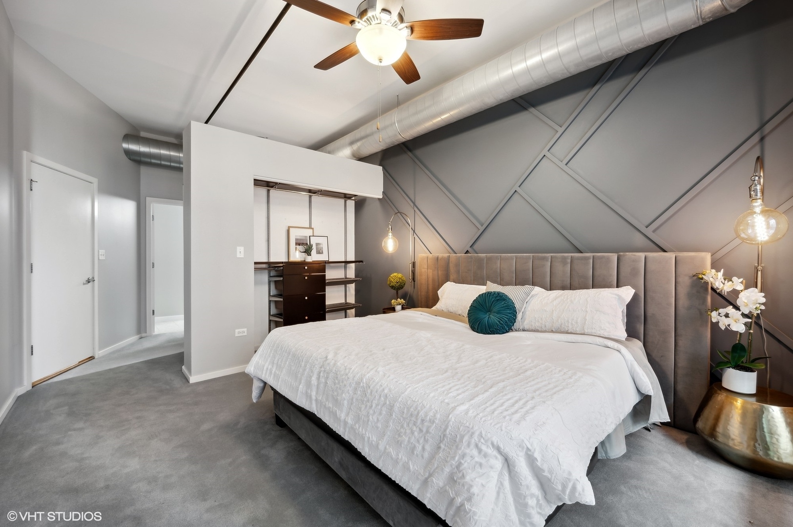 520 South State Street, Unit 908 Chicago, IL 60605 - Photo 8 of 16 a bedroom with a large bed and a chandelier