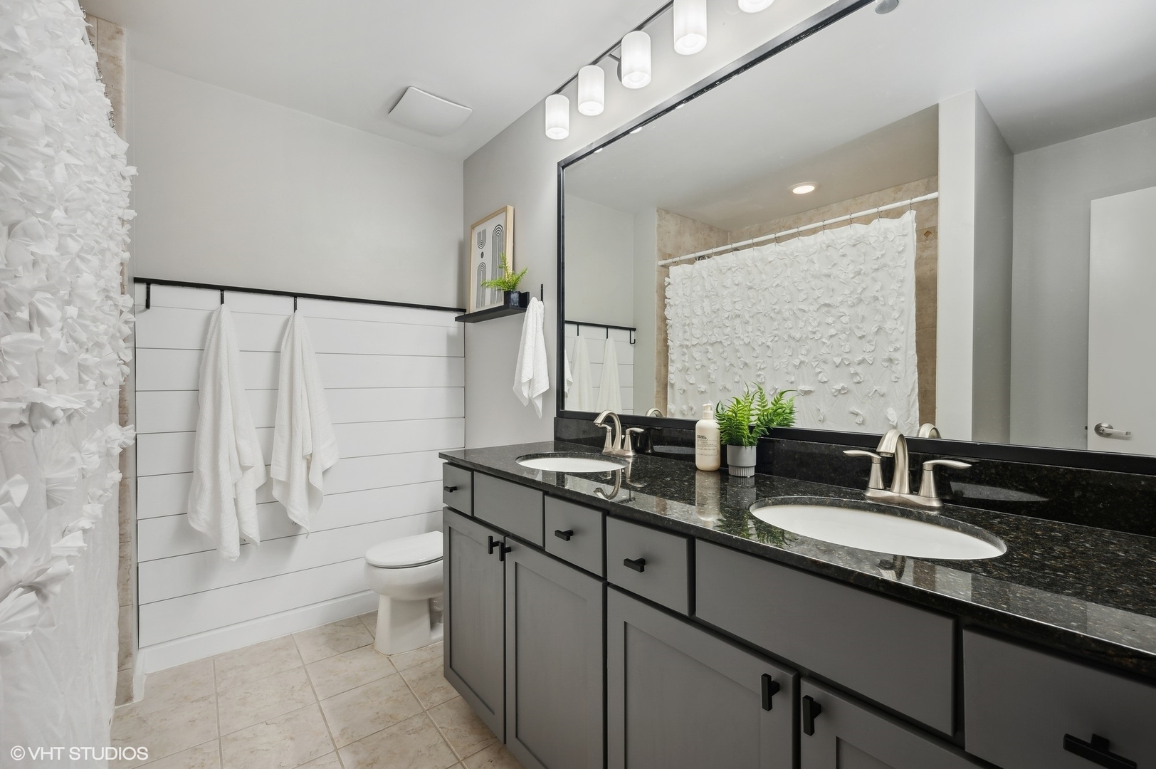 520 South State Street, Unit 908 Chicago, IL 60605 - Photo 9 of 16 a bathroom with a double vanity sink toilet and shower
