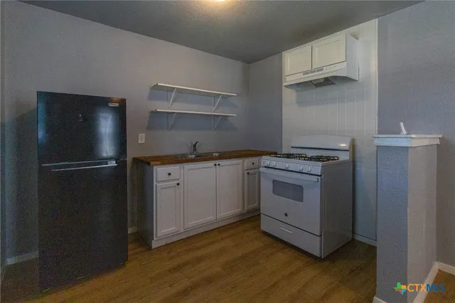 a kitchen with a stove and a refrigerator