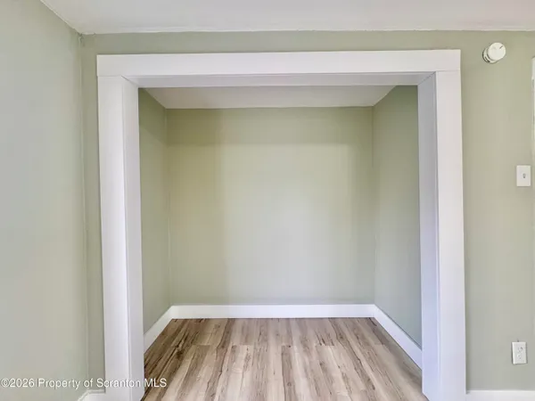 a view of a small room with wooden floor