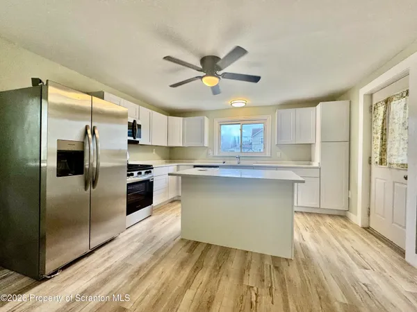 a kitchen with a refrigerator and a sink