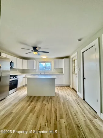 a view of kitchen with cabinets