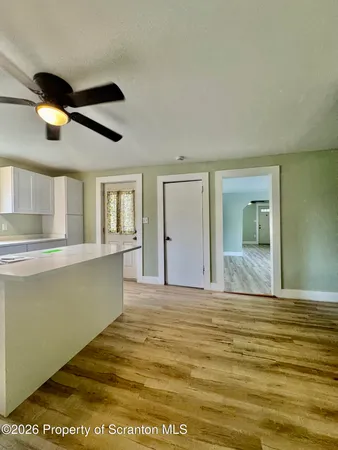 a view of a kitchen with a sink and cabinet