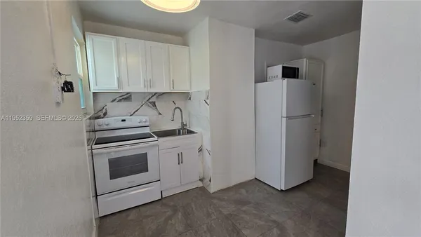 a view of a kitchen with washer and dryer