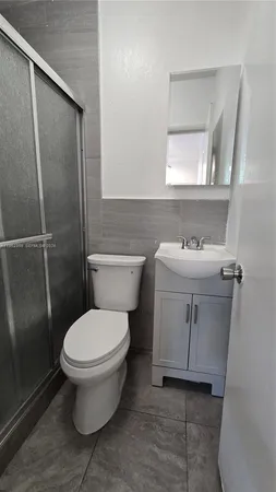 a white toilet sitting next to a bathroom sink