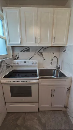 a view of a kitchen with stove top oven