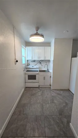a kitchen with a stove and a refrigerator