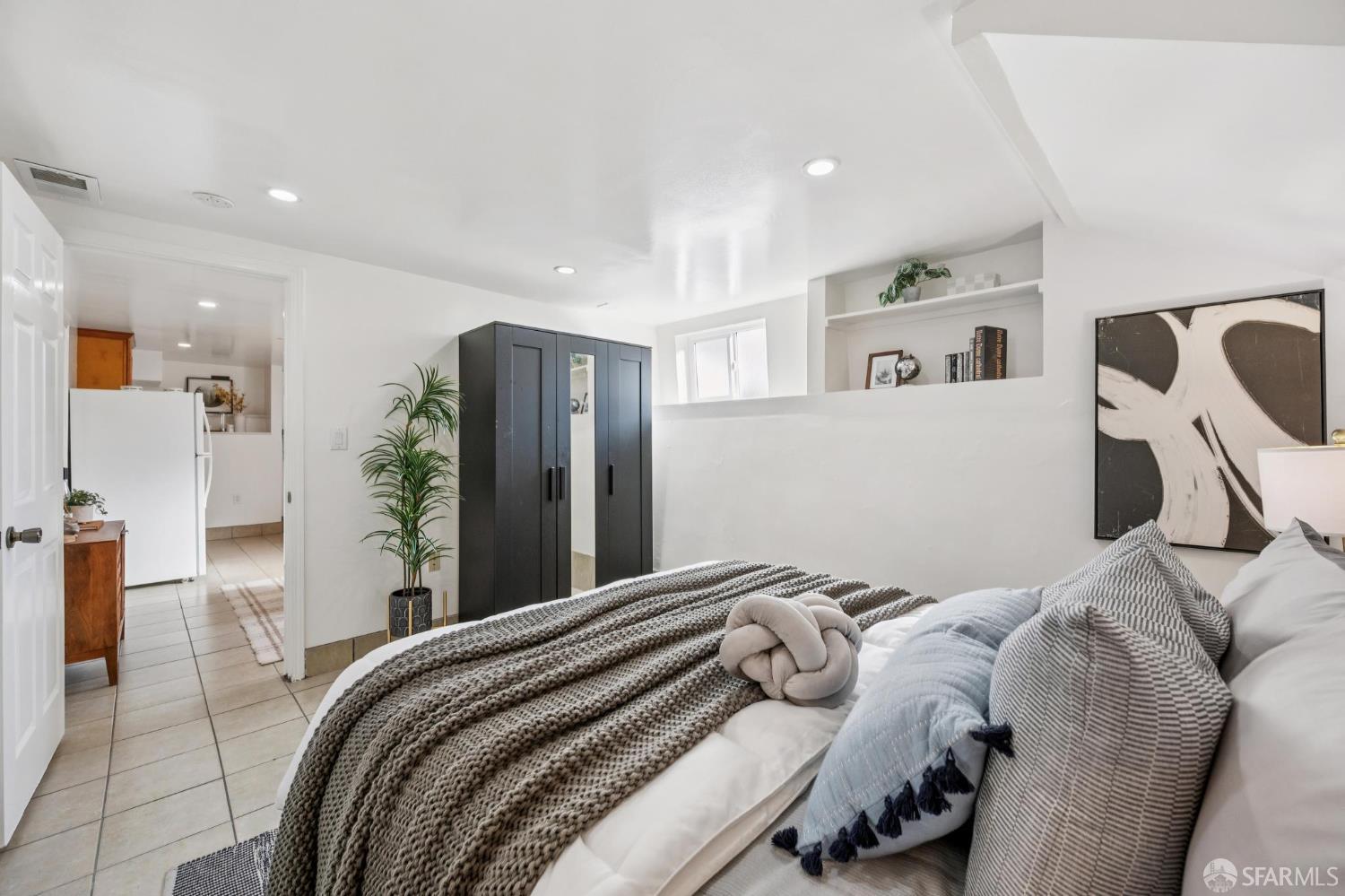 180 Ocean Avenue San Francisco, CA 94112 - Photo 48 of 62 a bedroom with a bed and a large mirror