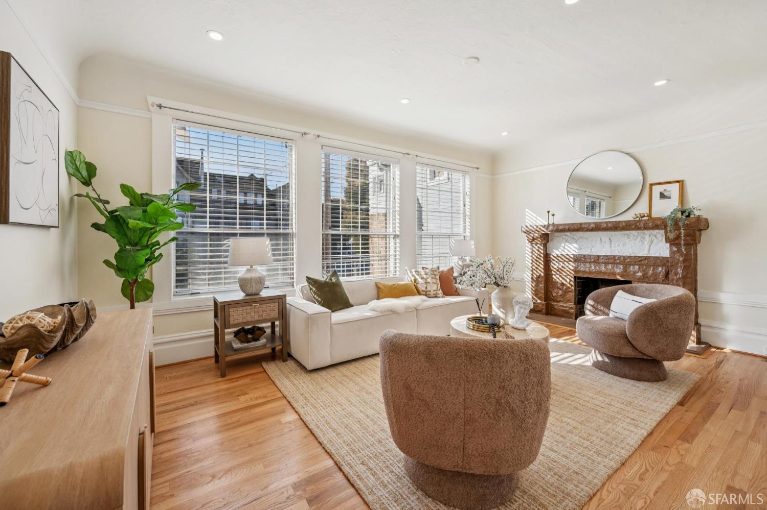 180 Ocean Avenue San Francisco, CA 94112 - Photo 9 of 62 a living room with furniture a fireplace and potted plants