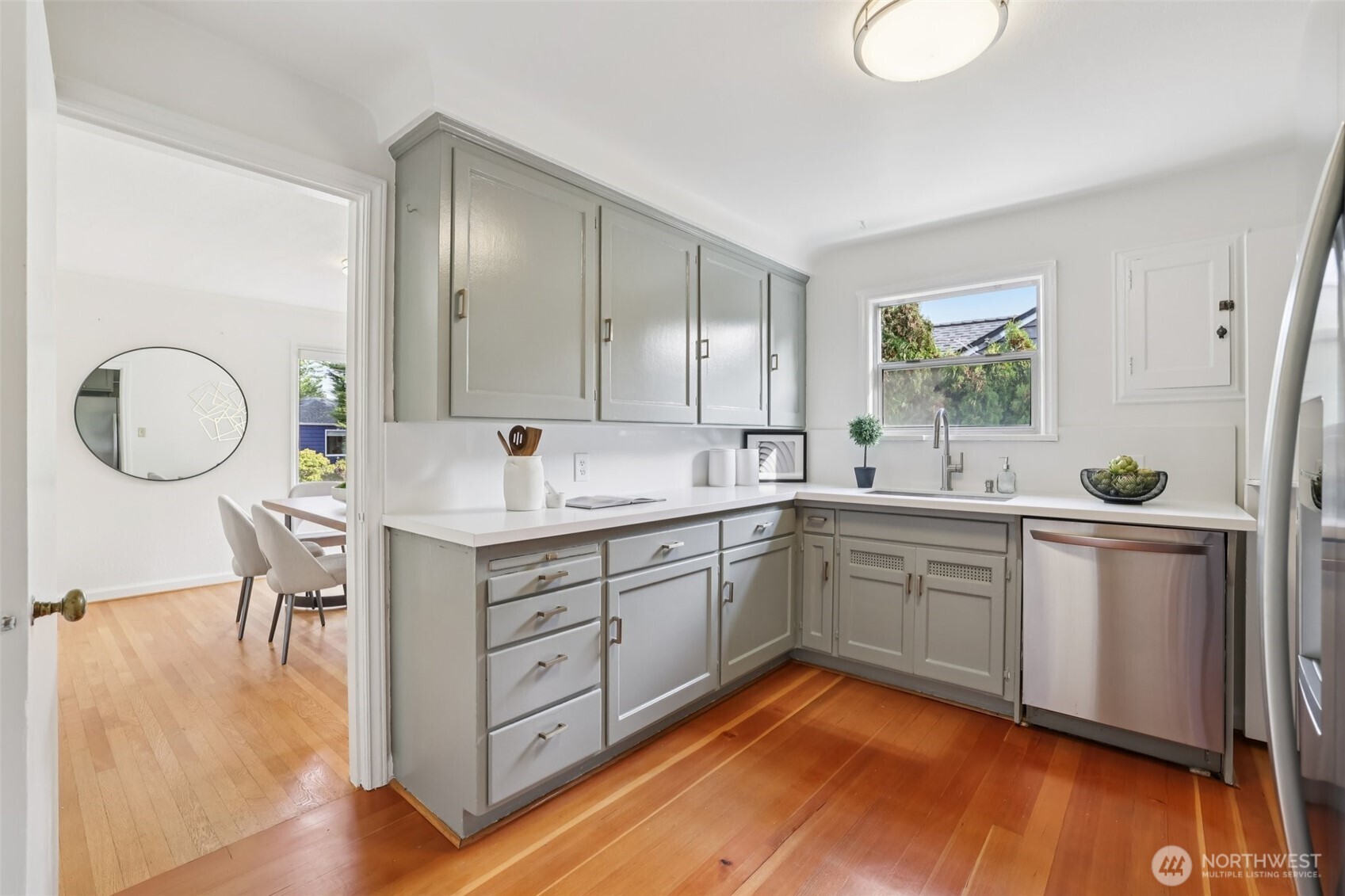 819 Northwest 80th Street Seattle, WA 98117 - Photo 11 of 37 a kitchen with a sink cabinets and wooden floor