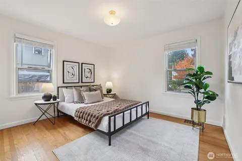 a bedroom with a bed and a potted plant
