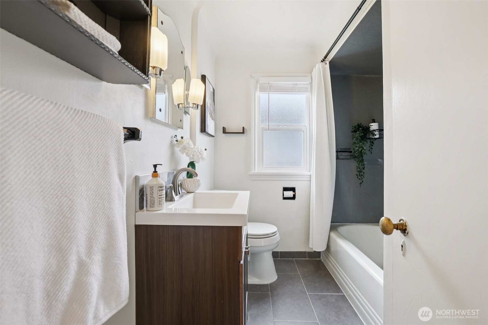 819 Northwest 80th Street Seattle, WA 98117 - Photo 17 of 37 a bathroom with a sink toilet and shower