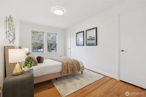 a bedroom with a bed and wooden floor