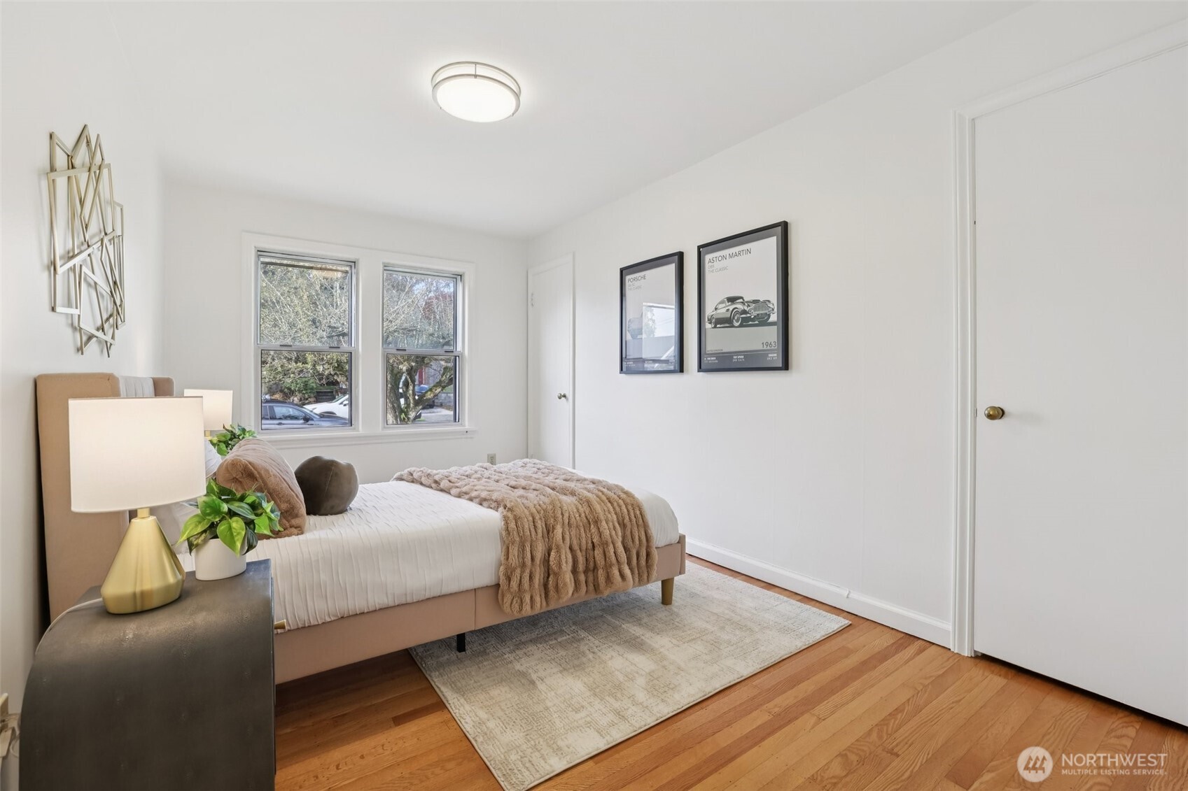 819 Northwest 80th Street Seattle, WA 98117 - Photo 20 of 37 a bedroom with a bed and wooden floor