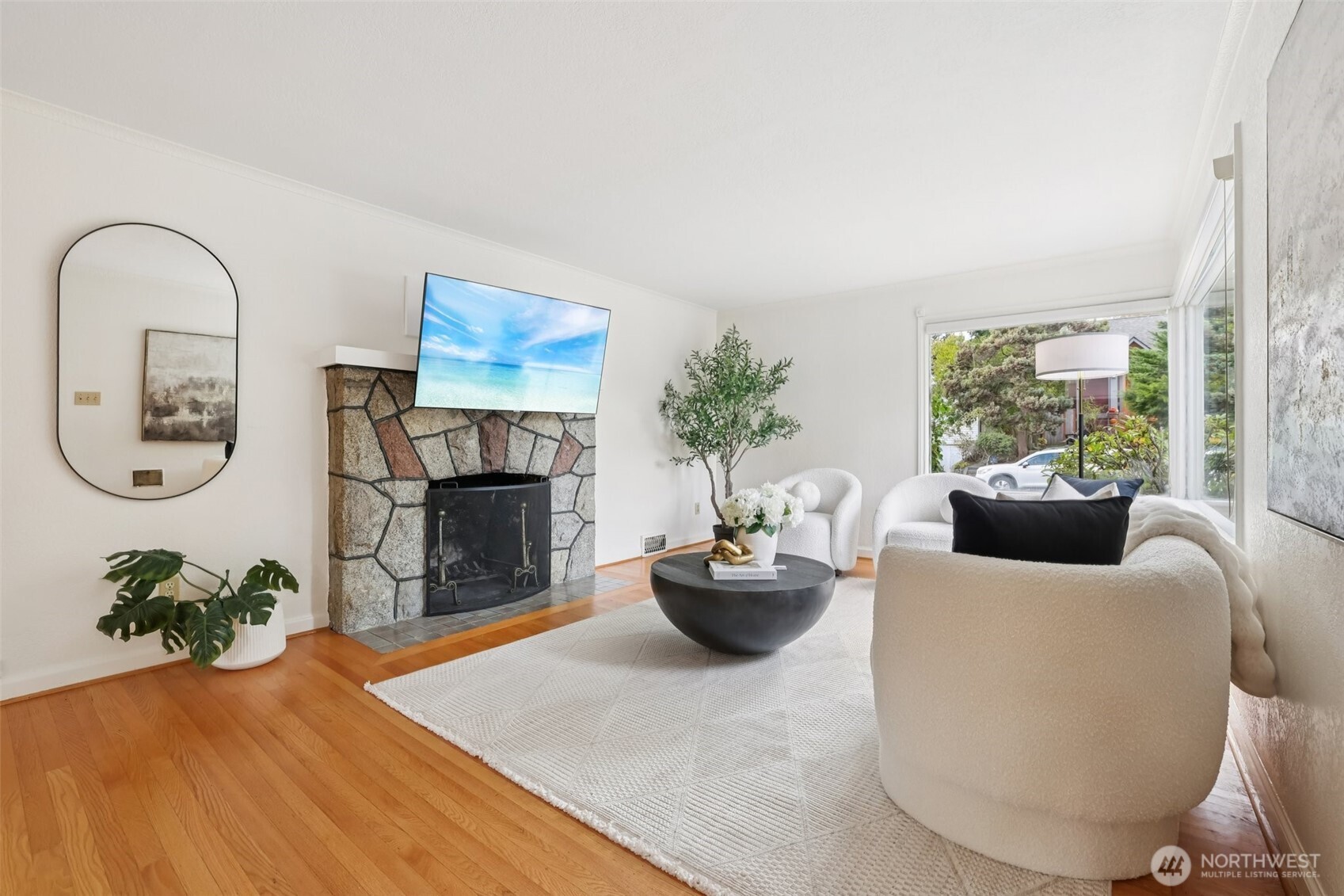 819 Northwest 80th Street Seattle, WA 98117 - Photo 7 of 37 a living room with furniture a fireplace and a potted plant