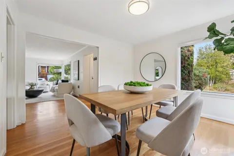 a living room with furniture a window and a potted plant