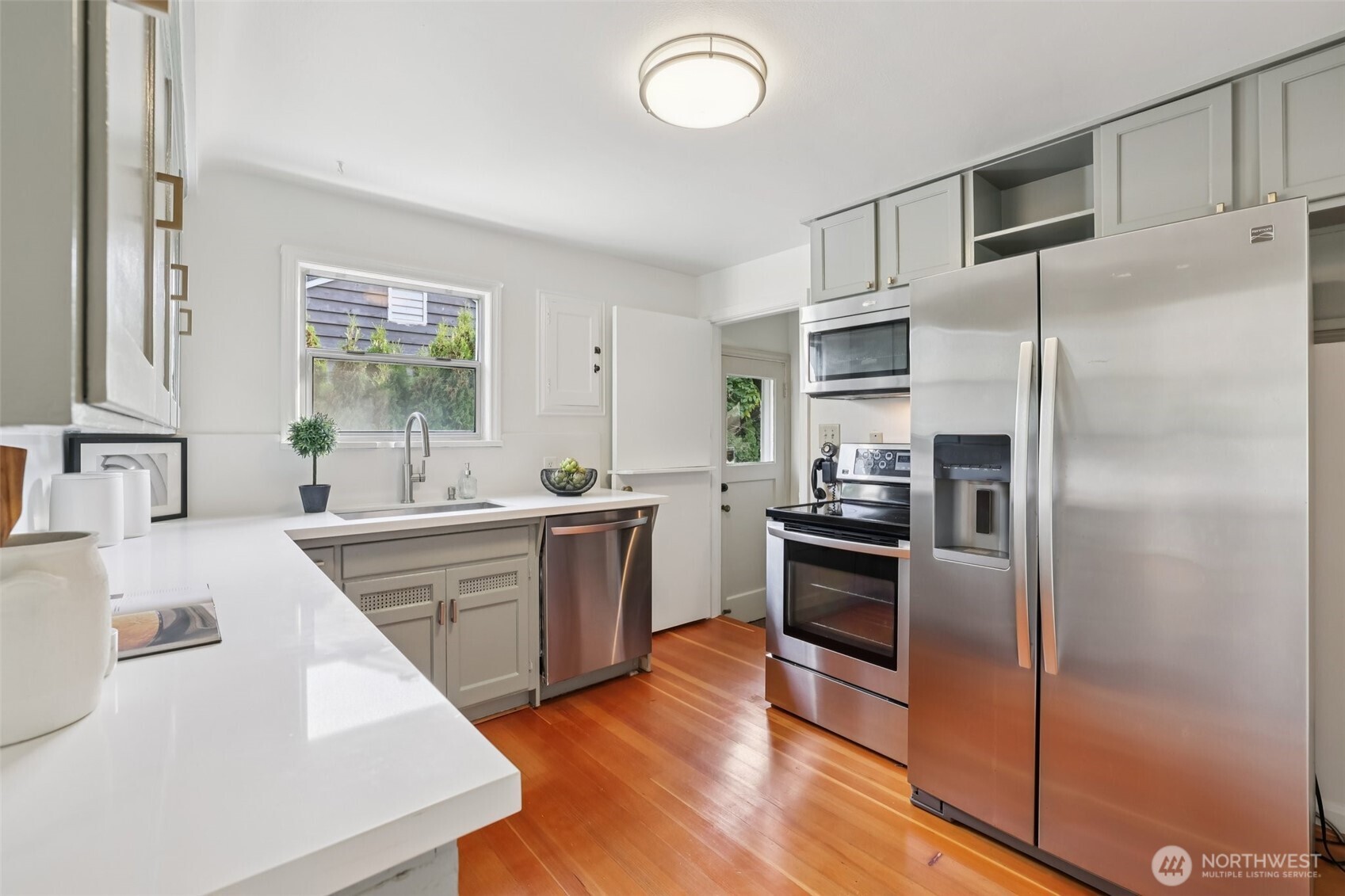 819 Northwest 80th Street Seattle, WA 98117 - Photo 10 of 37 a kitchen with stainless steel appliances a refrigerator sink and stove
