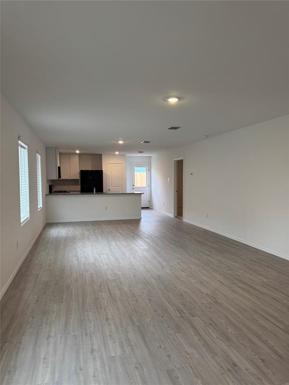 11719 Bone Spg Drive Rhome, TX 76078 - Photo 3 of 18 a view of a kitchen with a sink and a stove top oven