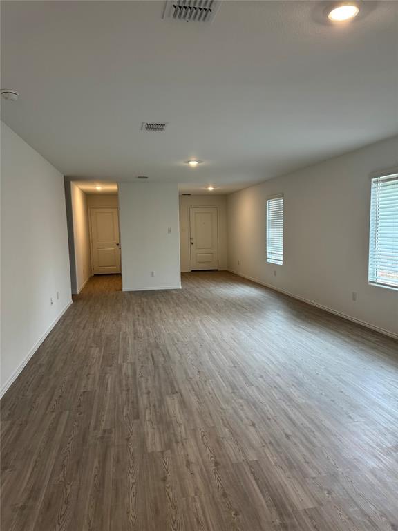 11719 Bone Spg Drive Rhome, TX 76078 - Photo 4 of 18 an empty room with wooden floor and windows