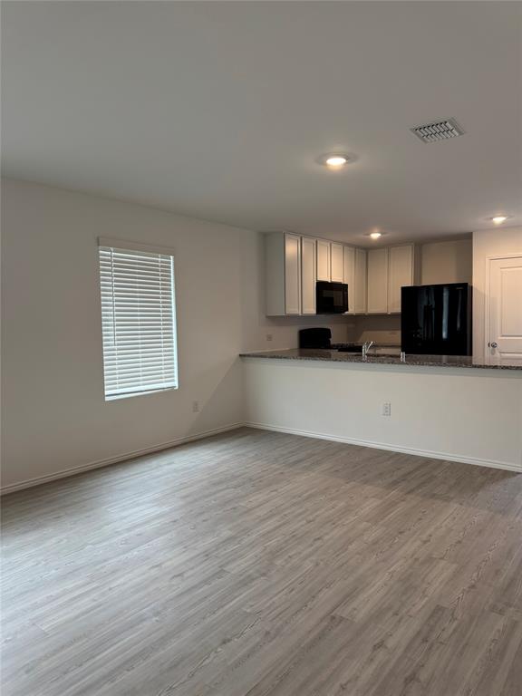 11719 Bone Spg Drive Rhome, TX 76078 - Photo 5 of 18 a view of kitchen with microwave and cabinets