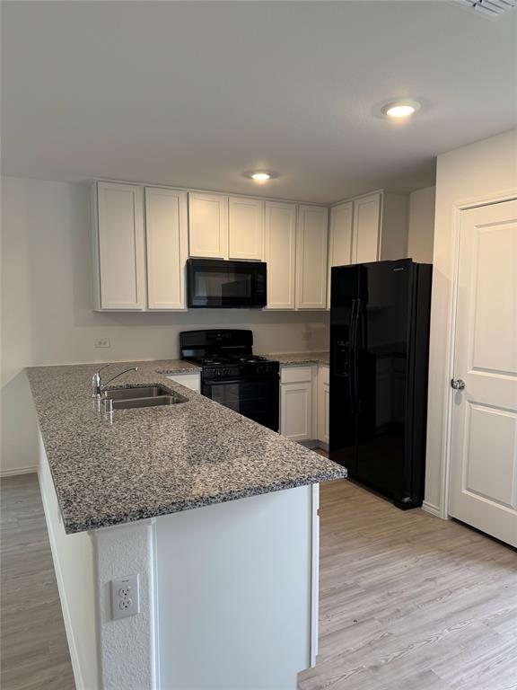 11719 Bone Spg Drive Rhome, TX 76078 - Photo 7 of 18 a kitchen with stainless steel appliances granite countertop a refrigerator and a sink
