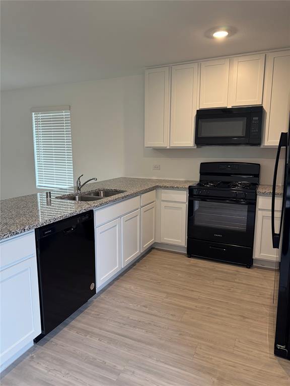 11719 Bone Spg Drive Rhome, TX 76078 - Photo 8 of 18 a kitchen with a sink stove and cabinets