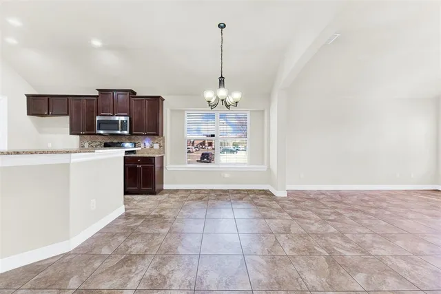 a view of a kitchen with a sink microwave and cabinets