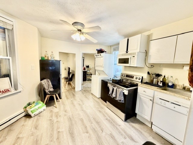 14 Cleveland Place, Unit 2 Boston, MA 02113 - Photo 7 of 18 a kitchen with a stove a sink and a refrigerator