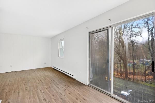 15 White Gate Road, Unit D Wappingers Falls, NY 12590 - Photo 11 of 16 a view of an empty room with wooden floor and a window