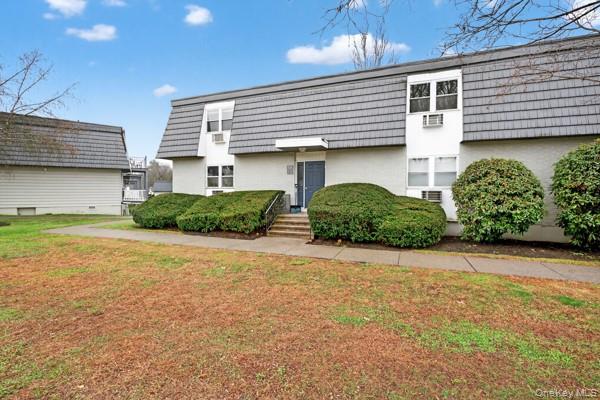 15 White Gate Road, Unit D Wappingers Falls, NY 12590 - Photo 2 of 16 a view of a house with potted plants and a car parked in front of it