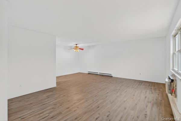 15 White Gate Road, Unit D Wappingers Falls, NY 12590 - Photo 5 of 16 an empty room with wooden floor and window