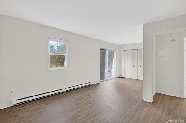 15 White Gate Road, Unit D Wappingers Falls, NY 12590 - Photo 10 of 16 an empty room with wooden floor and windows