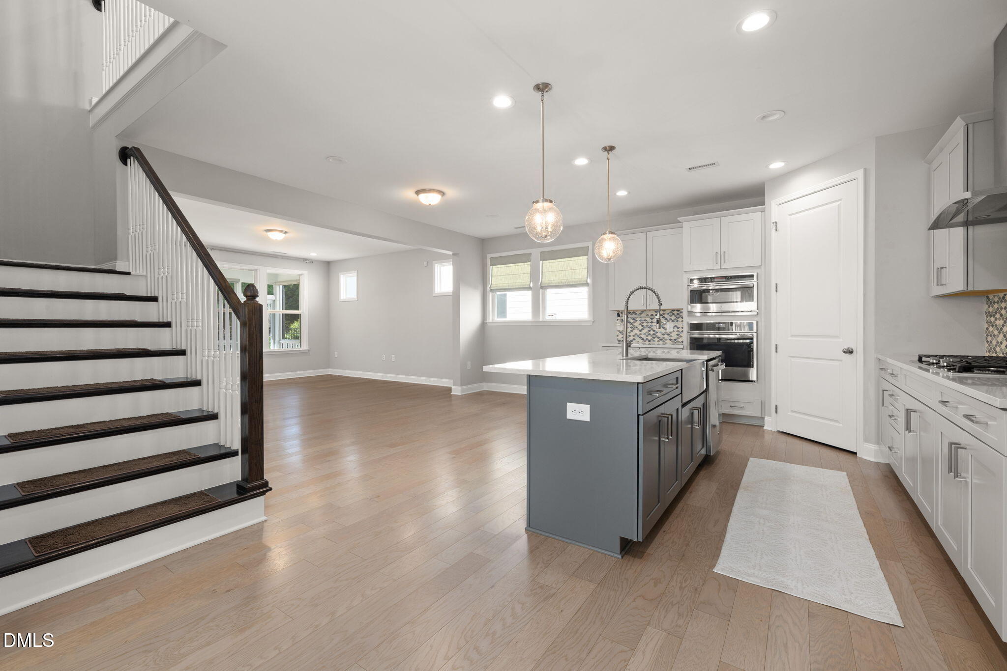 1015 Pondfield Way Durham, NC 27713 - Photo 10 of 48 a large kitchen with stainless steel appliances kitchen island granite countertop a stove a sink a refrigerator and a view of living room