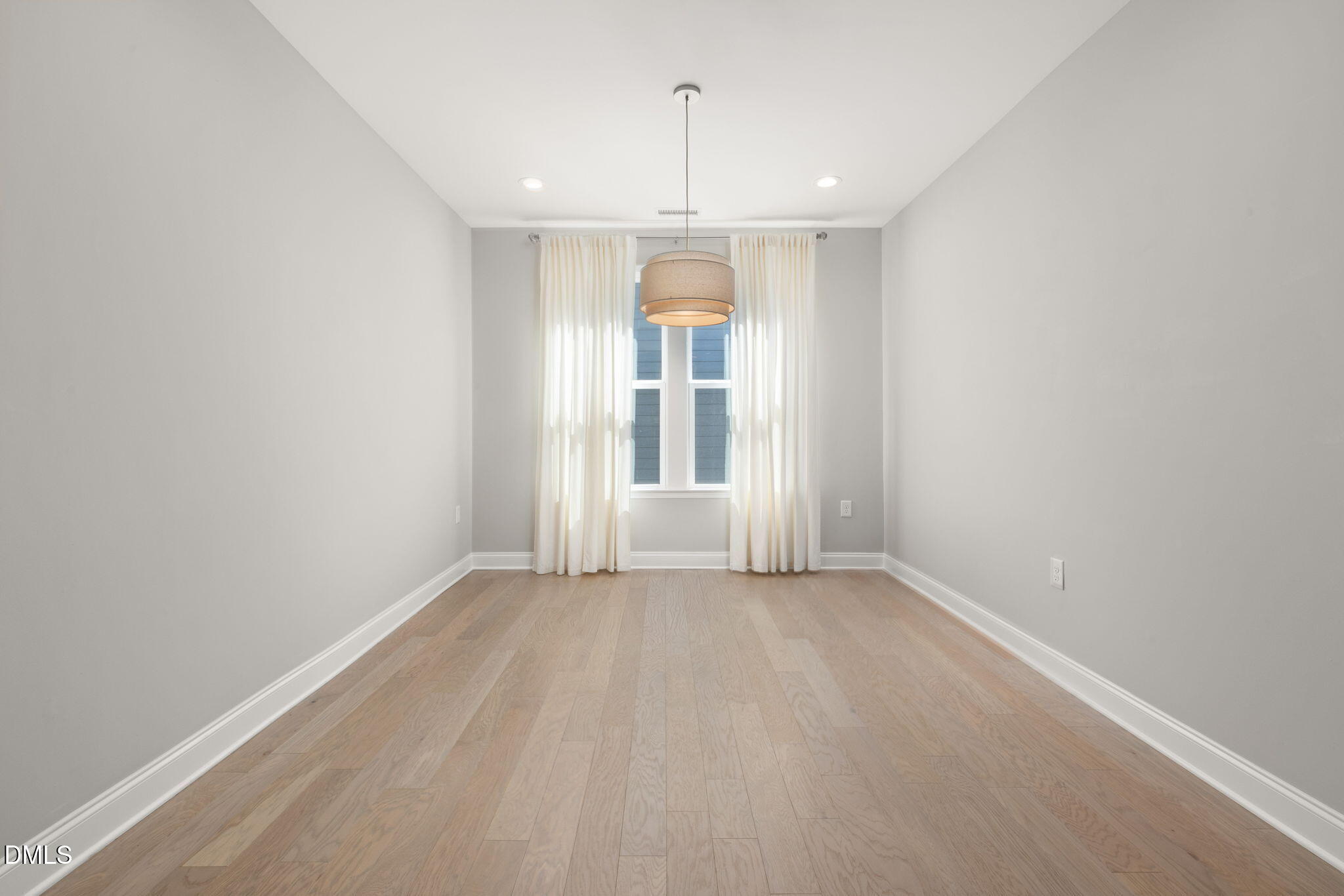 1015 Pondfield Way Durham, NC 27713 - Photo 12 of 48 an empty room with a window and chandelier