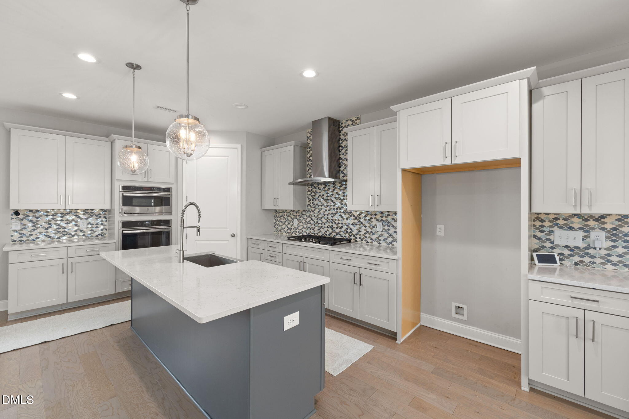 1015 Pondfield Way Durham, NC 27713 - Photo 16 of 48 a kitchen with white cabinets and stainless steel appliances