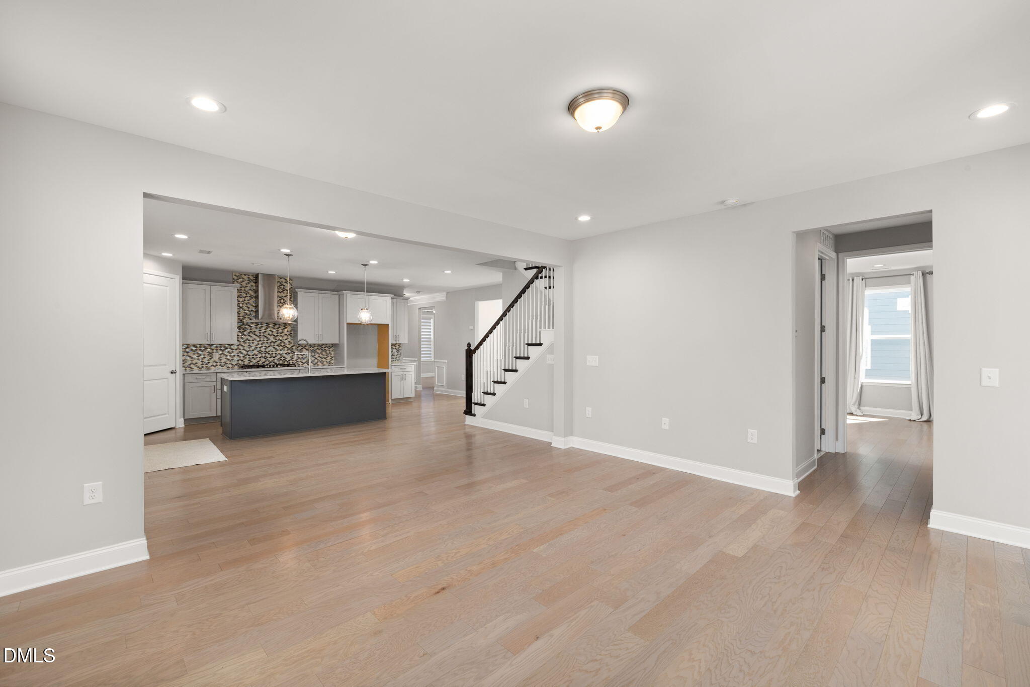 1015 Pondfield Way Durham, NC 27713 - Photo 18 of 48 an empty room with wooden floor and kitchen